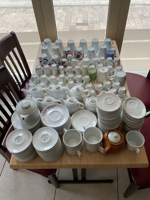 a table with a lot of dishes and cups on it