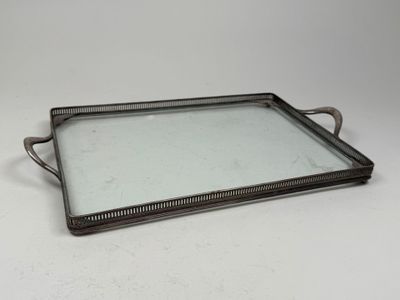 a metal tray with a glass top on a white surface