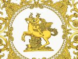 a close up of a gold plate with a horse on it