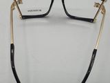 a pair of black and gold glasses on a white surface