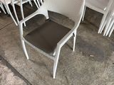 a lot of chairs that are sitting on the concrete