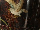 a decorative box with a bird on it sitting on a table