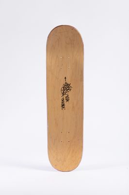the skateboard is made of wood and has a black writing on it