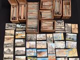 a large collection of old postcards and postcards on a table