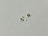 a pair of white diamonds sitting on top of a white surface