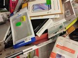 a pile of cell phones and other electronic items on a table