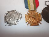 two medals and a hat on a table