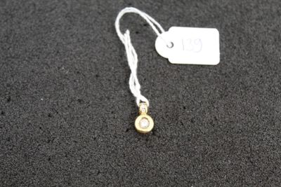 a close up of a tag on a black surface with a white tag
