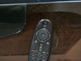 a remote control sitting on the side of a tv