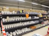 many cups and mugs on the shelves in the store
