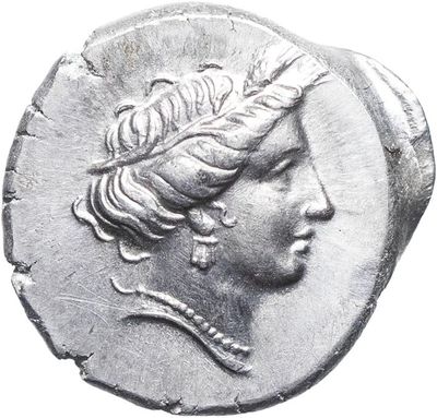 a close up of a coin with a woman ' s head on it