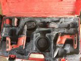 a red tool case with tools in it on the floor