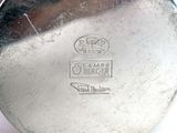 a close up of a silver plate with a logo on it
