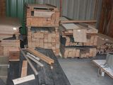several stacks of wood are stacked on top of each other in a warehouse