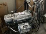 a machine that is sitting on the floor next to a toilet