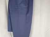 navy blue dress pants with a bow tie on a white background