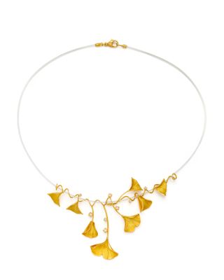 a close up of a necklace on a white background