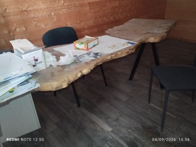 a table with a bunch of papers on it in a room