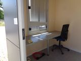 a desk with a chair in front of a window