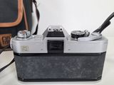 a camera sitting on a table next to a bag