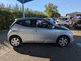 the silver car is parked in the parking lot with other cars in the background