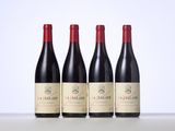 three bottles of red wine sitting on top of a table