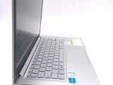 a silver laptop with a blue keyboard on a white surface