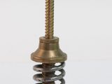 a bottle opener that is sitting on top of a spring