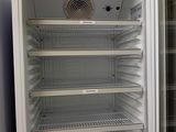 an open refrigerator with a lot of shelves in it