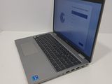 the laptop is sitting on the table with the screen open