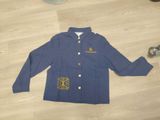 veste d'école bleue avec des lettres dorées sur le devant et un emblème jaune dans le dos