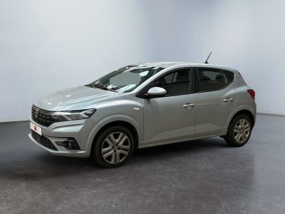 a silver car is parked in a room with a white wall