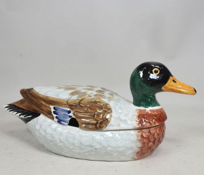 a ceramic duck that is sitting on a table