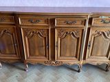 a wooden sideboard with drawers on it in a living room