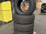 four tires stacked on top of each other in a warehouse