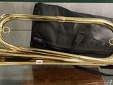 a brass trumpet sitting on a glass table