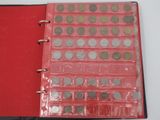 a red binder with a lot of coins on it