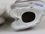 a close up of a white porcelain object with a label on it