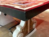 a close up of a table with a red wall in the background