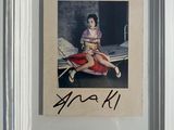 signed photograph of a woman sitting on top of a red car