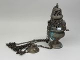 an old metal object with a chain around it and a bell