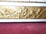 a gold and white bed with a red carpet