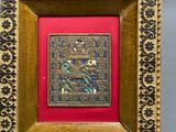 an ornate gold frame with a picture of a bird and flowers on it