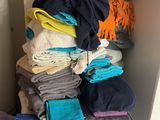 a stack of folded clothes on top of a washing machine