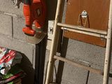 a ladder leaning against a wall next to a bed