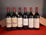 six bottles of red wine are lined up on a red table