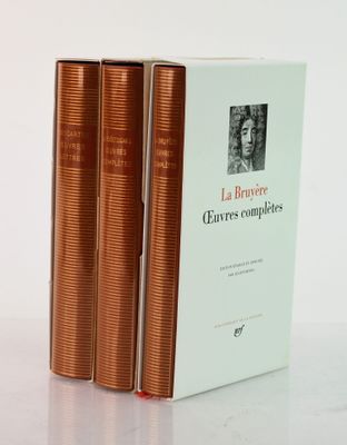 three books sitting on top of a white table next to each other