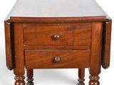 a small wooden table with a drawer on it