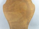 a large wooden plate with a gold decoration on it