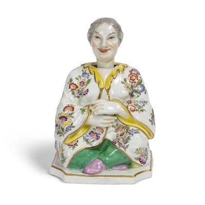 une figurine chinoise représentant une femme tenant un pot de fleurs